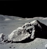 Apollo 17 astronaut Harrison Schmitt standing next to boulder at Taurus-Littrow during third EVA (extravehicular activity). NASA&nbsp;photo.